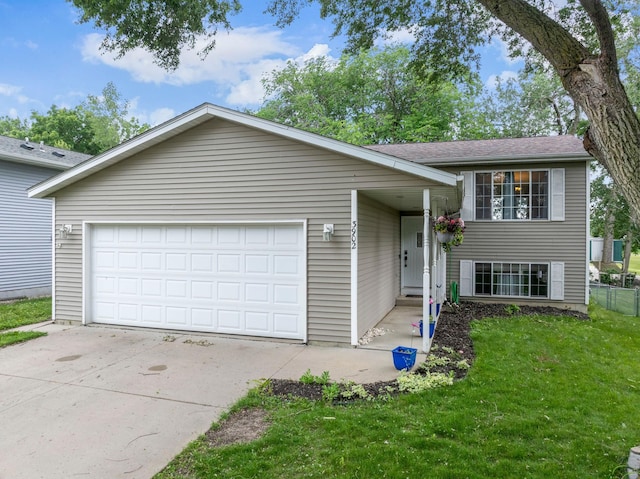 3902 Strathmore Ln SE, Rochester, MN 55904 - tri-level home with a front lawn, concrete driveway, and a garage