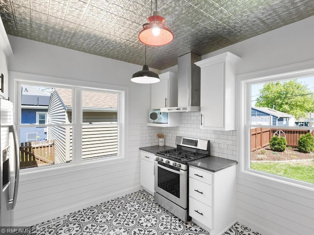 3201 Xenwood Ave S, Saint Louis Park, MN 55416 - kitchen featuring stainless steel appliances, wall chimney exhaust hood, dark countertops, an ornate ceiling, and white cabinetry