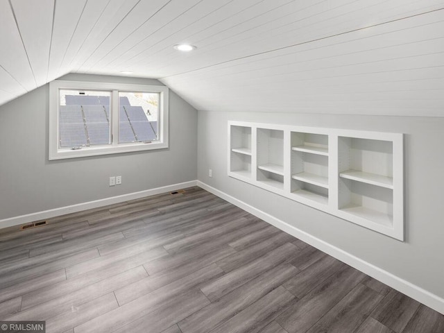 3201 Xenwood Ave S, Saint Louis Park, MN 55416 - bonus room featuring wood finished floors, vaulted ceiling, and built in shelves