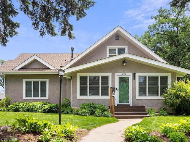 3201 Xenwood Ave S, Saint Louis Park, MN 55416 - view of front of home with stucco siding, a front lawn, and a shingled roof