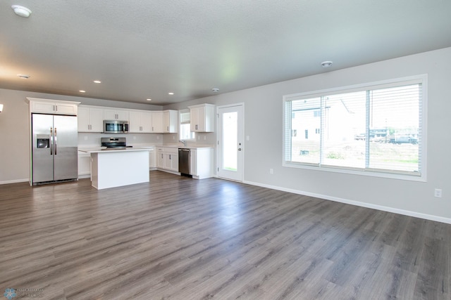1449 68th Ave S, Fargo, ND 58104 - unfurnished living room featuring dark wood-style flooring and recessed lighting