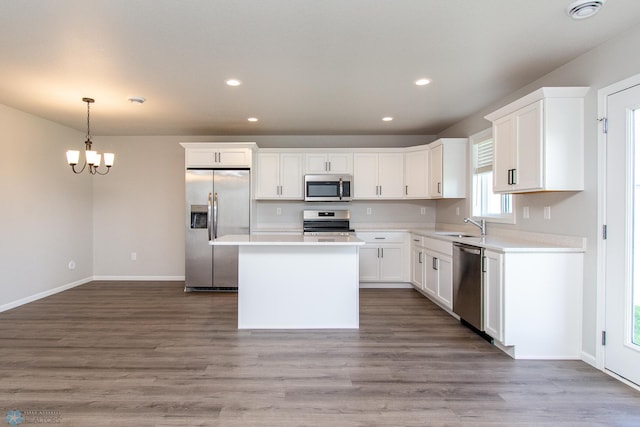 1449 68th Ave S, Fargo, ND 58104 - kitchen featuring stainless steel appliances, recessed lighting, a chandelier, white cabinets, and light countertops