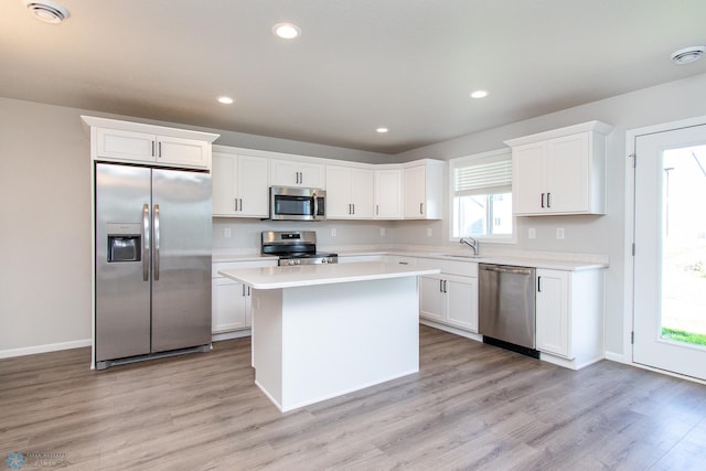 1449 68th Ave S, Fargo, ND 58104 - kitchen with stainless steel appliances, light countertops, a kitchen island, white cabinets, and recessed lighting