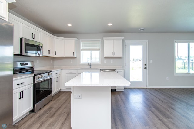 1449 68th Ave S, Fargo, ND 58104 - kitchen with appliances with stainless steel finishes, light wood-style floors, healthy amount of natural light, a kitchen island, and recessed lighting