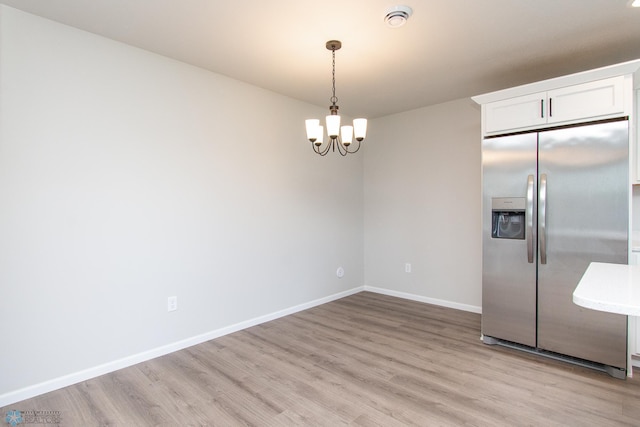 1449 68th Ave S, Fargo, ND 58104 - unfurnished dining area with light wood finished floors and a chandelier