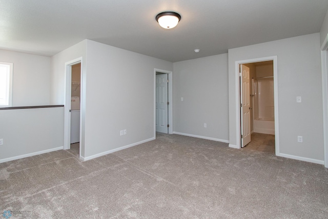 1449 68th Ave S, Fargo, ND 58104 - unfurnished bedroom featuring carpet flooring, a spacious closet, and ensuite bath