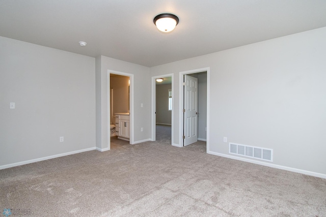 1449 68th Ave S, Fargo, ND 58104 - unfurnished bedroom featuring light carpet and ensuite bath