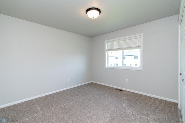 1449 68th Ave S, Fargo, ND 58104 - carpeted empty room with baseboards