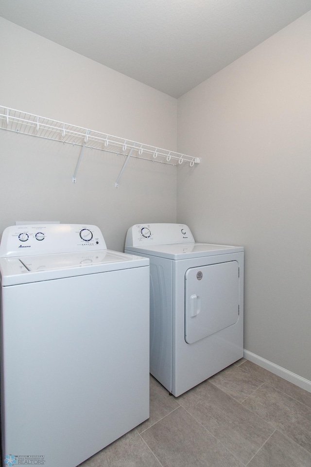 1449 68th Ave S, Fargo, ND 58104 - laundry area featuring washer and clothes dryer and light tile patterned floors