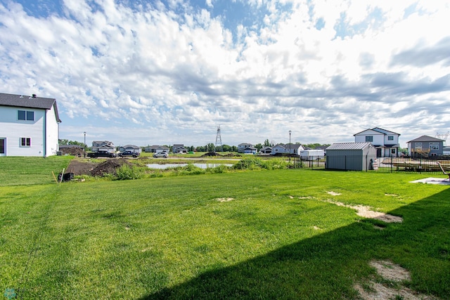 1449 68th Ave S, Fargo, ND 58104 - view of yard with a water view, a residential view, and a storage shed