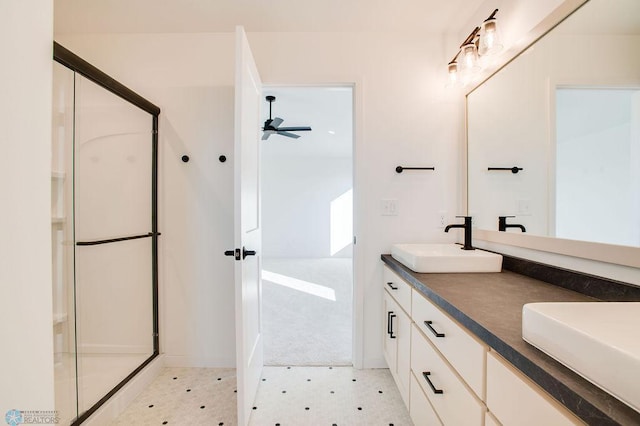 419 Reese Way, Mapleton, ND 58059 - bathroom with double vanity, a ceiling fan, a stall shower, and tile patterned floors