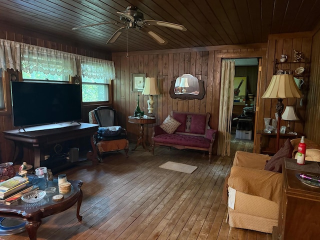40257 Elbow Lake Store Rd, Round Lake N Twp, MN 56589 - living area featuring wood ceiling, hardwood / wood-style flooring, a ceiling fan, and wooden walls