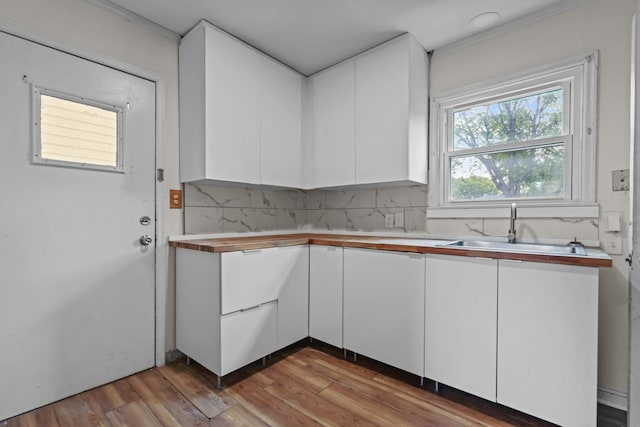 1289 Galtier St, Saint Paul, MN 55117 - kitchen featuring white cabinetry, wood finished floors, and tasteful backsplash