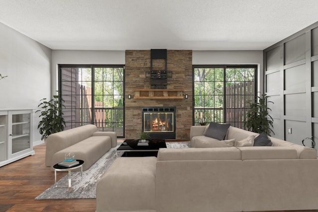 1237 Hillwind Rd NE, Fridley, MN 55432 - living area featuring a textured ceiling, wood finished floors, plenty of natural light, and a fireplace