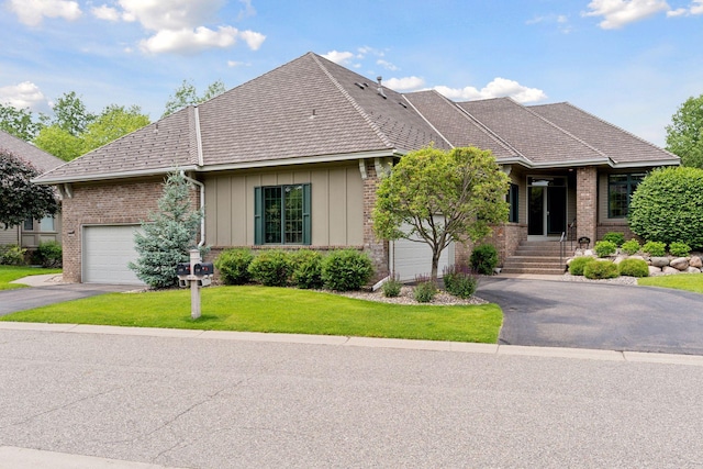 343 Waycliffe Dr N, Wayzata, MN 55391 - view of front facade featuring driveway, brick siding, a front lawn, board and batten siding, and a garage