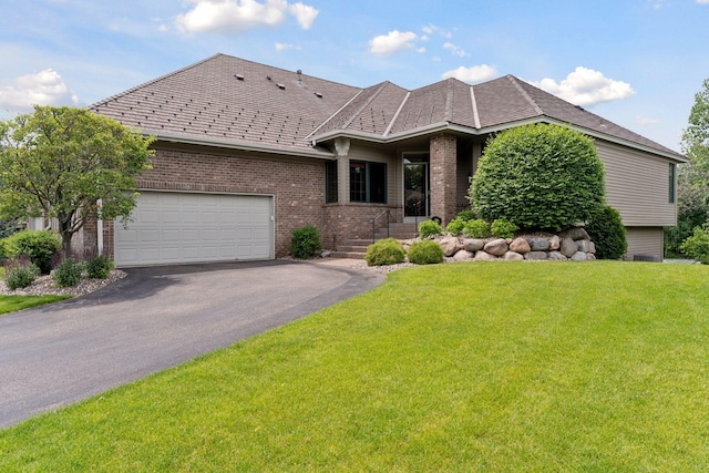 343 Waycliffe Dr N, Wayzata, MN 55391 - view of front of home with brick siding, driveway, a front yard, and a garage