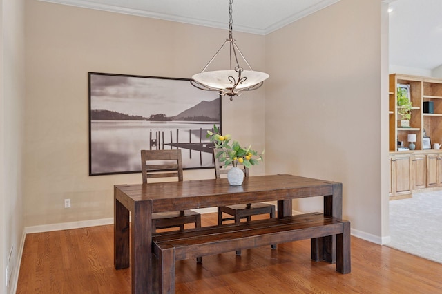 343 Waycliffe Dr N, Wayzata, MN 55391 - dining space featuring a chandelier, wood finished floors, and ornamental molding
