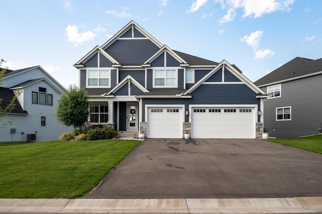 15560 110th Ave N, Dayton, MN 55369 - craftsman-style home featuring driveway, an attached garage, stone siding, and a front lawn
