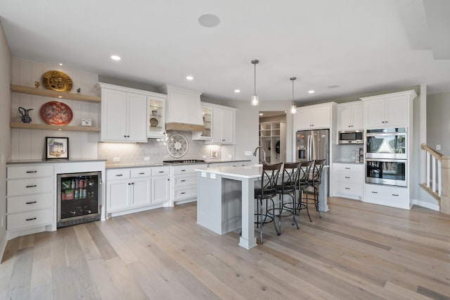 15560 110th Ave N, Dayton, MN 55369 - kitchen with wine cooler, stainless steel appliances, open shelves, light wood-style flooring, and recessed lighting