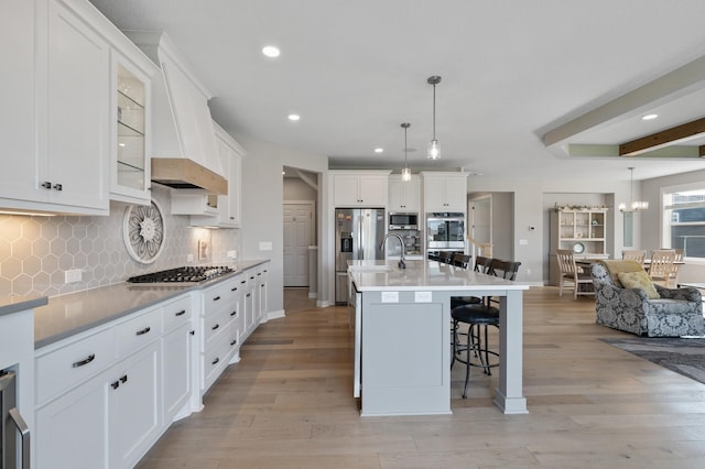 15560 110th Ave N, Dayton, MN 55369 - kitchen with stainless steel appliances, a kitchen breakfast bar, recessed lighting, decorative backsplash, and light wood-style flooring