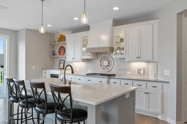 15560 110th Ave N, Dayton, MN 55369 - kitchen with open shelves, stainless steel gas cooktop, light wood-style flooring, tasteful backsplash, and hanging light fixtures