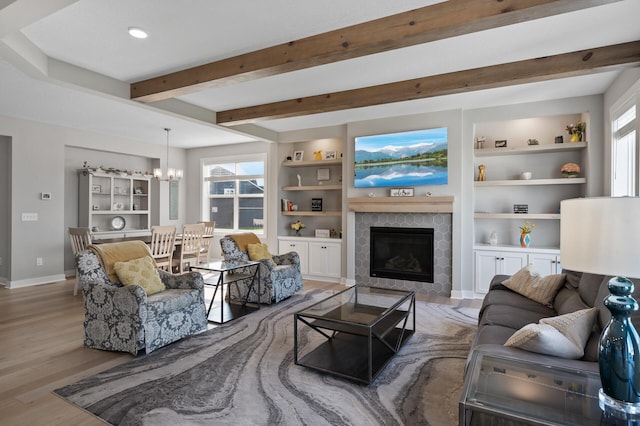 15560 110th Ave N, Dayton, MN 55369 - living room with wood finished floors, a chandelier, a tile fireplace, beam ceiling, and built in features