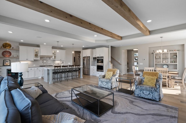 15560 110th Ave N, Dayton, MN 55369 - living area featuring light wood-type flooring, a chandelier, beamed ceiling, recessed lighting, and stairway