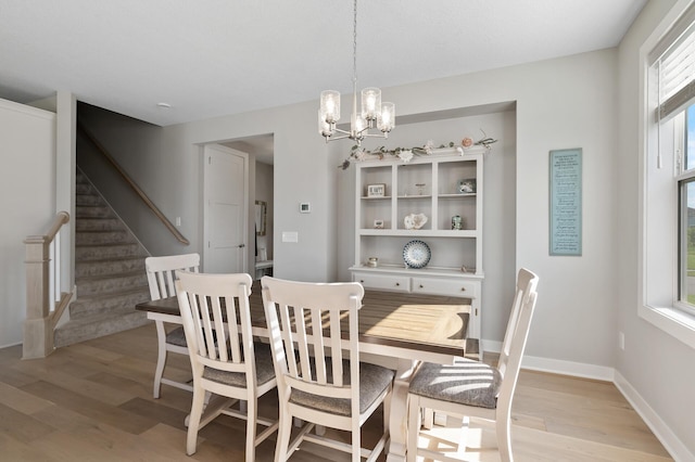15560 110th Ave N, Dayton, MN 55369 - dining room featuring light wood-style floors, stairway, and a chandelier