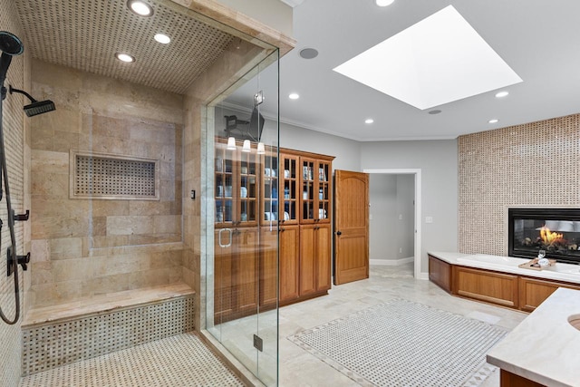 2172 Shadywood Rd, Orono, MN 55391 - bathroom with a shower stall, vanity, a skylight, recessed lighting, and a tiled fireplace