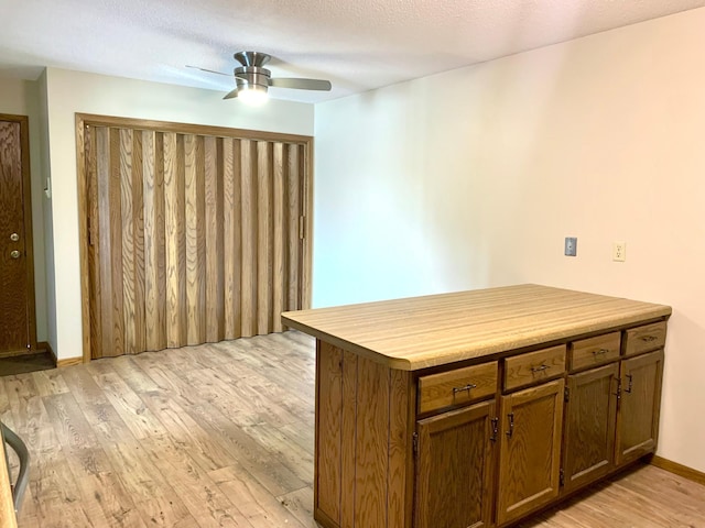 2419 25 1/2 Ave S Unit 205, Fargo, ND 58103 - kitchen featuring light wood-style floors, a ceiling fan, and light countertops