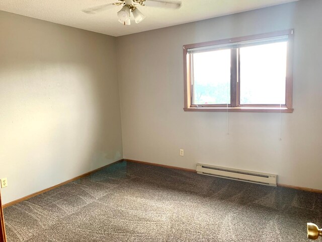 2419 25 1/2 Ave S Unit 205, Fargo, ND 58103 - carpeted empty room featuring a baseboard radiator and a ceiling fan