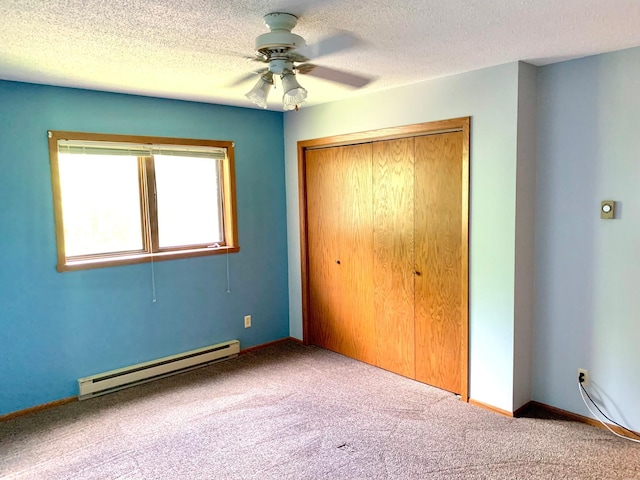 2419 25 1/2 Ave S Unit 205, Fargo, ND 58103 - unfurnished bedroom featuring a baseboard heating unit, carpet, a closet, ceiling fan, and a textured ceiling