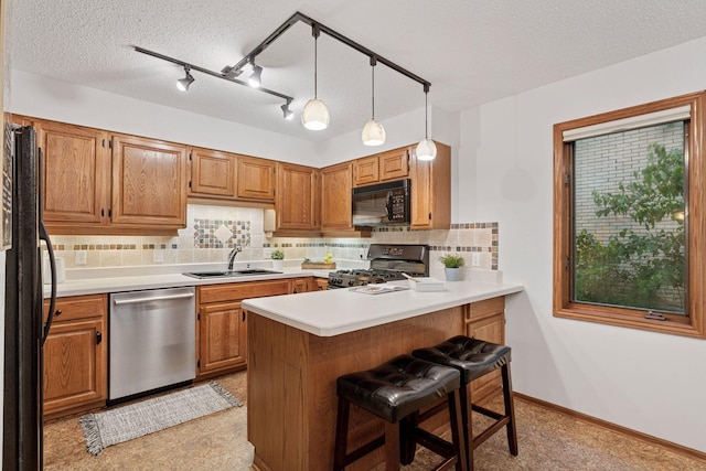 729 Summit Ave, Saint Paul, MN 55105 - kitchen featuring black appliances, backsplash, a peninsula, light countertops, and a textured ceiling