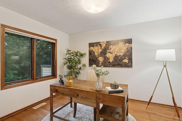 729 Summit Ave, Saint Paul, MN 55105 - office featuring wood finished floors, a textured ceiling, and healthy amount of natural light