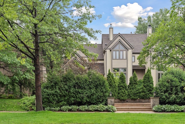 729 Summit Ave, Saint Paul, MN 55105 - back of house with a shingled roof, a lawn, and a chimney