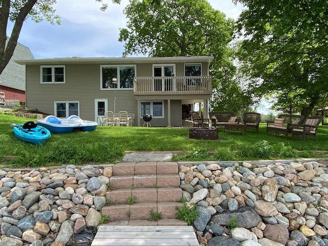 5960 165th St NE, Atwater, MN 56209 - rear view of property featuring a fire pit and a lawn