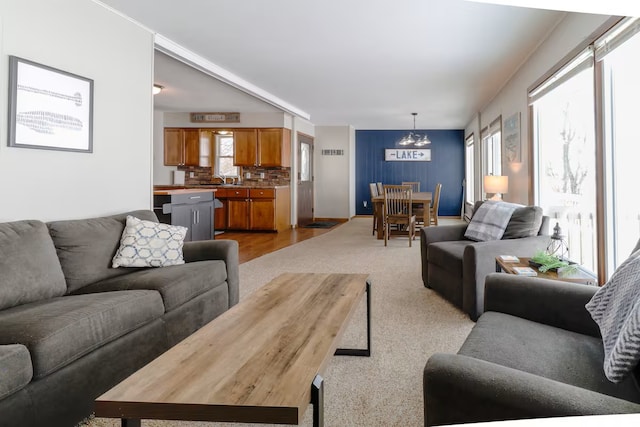 5960 165th St NE, Atwater, MN 56209 - living room featuring a chandelier and light colored carpet