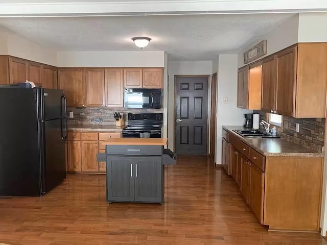 5960 165th St NE, Atwater, MN 56209 - kitchen with black appliances, tasteful backsplash, and light wood-style floors