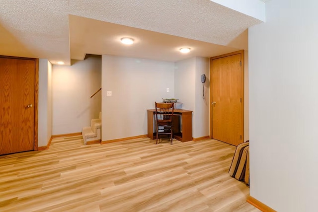 5960 165th St NE, Atwater, MN 56209 - finished below grade area featuring light wood-type flooring, a textured ceiling, and stairway