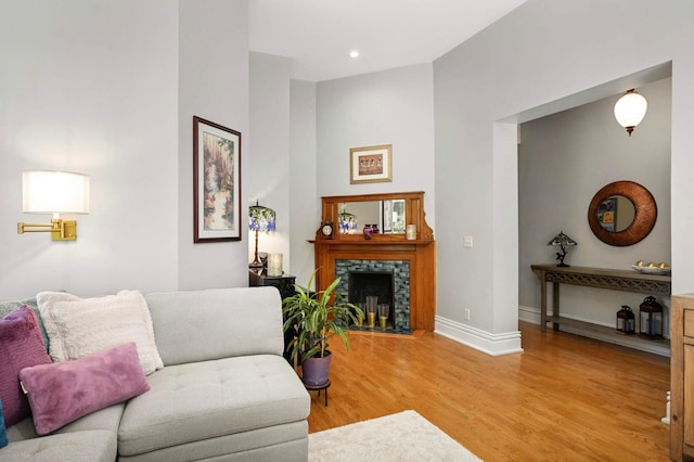 977 Portland Ave Unit 1, Saint Paul, MN 55104 - living room with light wood-style floors, a tile fireplace, and recessed lighting
