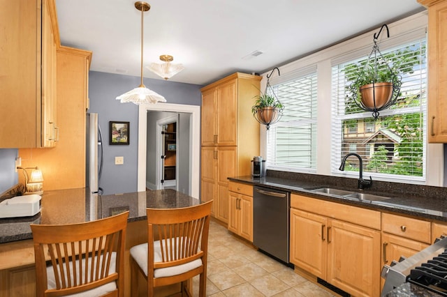977 Portland Ave Unit 1, Saint Paul, MN 55104 - kitchen featuring stainless steel dishwasher, fridge, a kitchen breakfast bar, hanging light fixtures, and dark stone countertops
