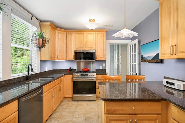 977 Portland Ave Unit 1, Saint Paul, MN 55104 - kitchen featuring stainless steel appliances, light tile patterned flooring, light brown cabinets, pendant lighting, and dark stone counters