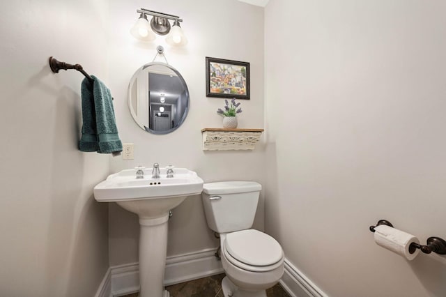 977 Portland Ave Unit 1, Saint Paul, MN 55104 - half bathroom featuring baseboards and toilet