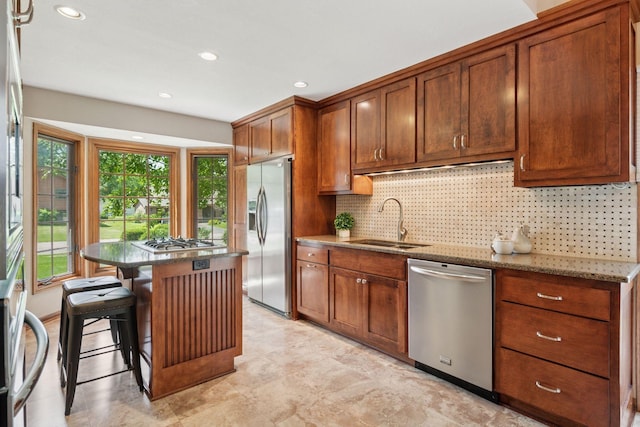 7516 Colorado Ave N, Brooklyn Park, MN 55443 - kitchen with appliances with stainless steel finishes, light stone countertops, a kitchen island, tasteful backsplash, and brown cabinetry