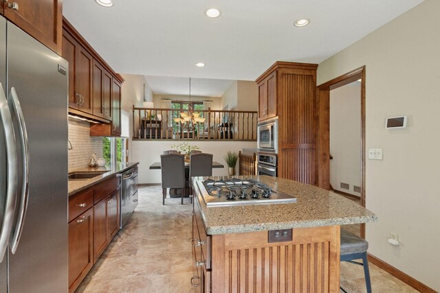 7516 Colorado Ave N, Brooklyn Park, MN 55443 - kitchen featuring stainless steel appliances, a chandelier, a kitchen island, recessed lighting, and backsplash