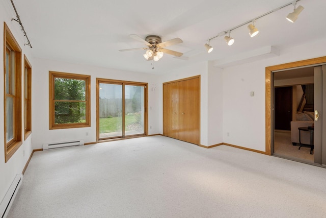 7516 Colorado Ave N, Brooklyn Park, MN 55443 - unfurnished bedroom featuring a baseboard heating unit, track lighting, access to exterior, and carpet floors
