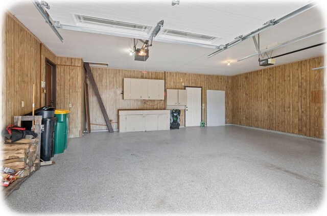7516 Colorado Ave N, Brooklyn Park, MN 55443 - garage with a garage door opener and wood walls