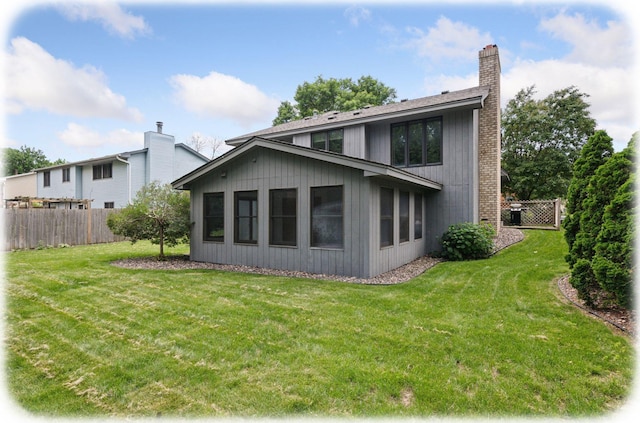 7516 Colorado Ave N, Brooklyn Park, MN 55443 - rear view of property featuring a chimney