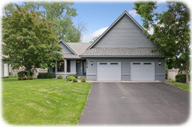 7516 Colorado Ave N, Brooklyn Park, MN 55443 - view of front of house with asphalt driveway, a garage, and roof with shingles
