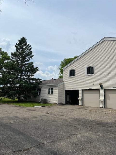 4918 Grenwich Trl N, Oakdale, MN 55128 - view of home's exterior featuring an attached garage and a cooling unit